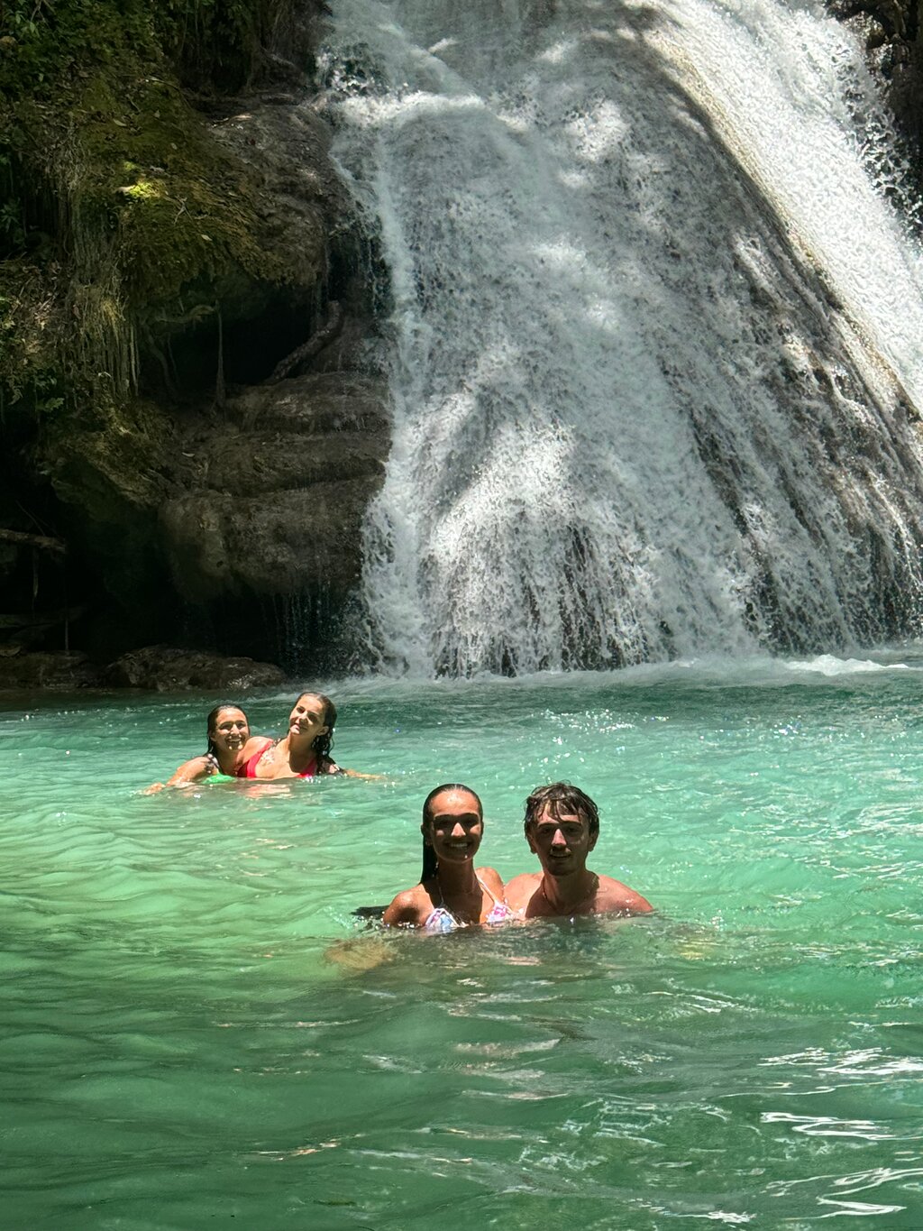 Visitors enjoying the Blue Hole waterfalls, a must-see destination near Montego Bay.
